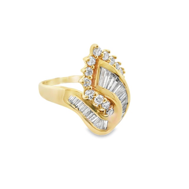 This fun fashion ring is made in 14k yellow gold and features both baguette and round cut diamonds. The unique shape and...