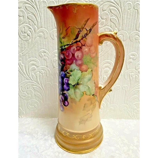 Gorgeous antique TV Limoge Hand Painted Grapes Tankard measuring 14 1/2" tall in good condition.