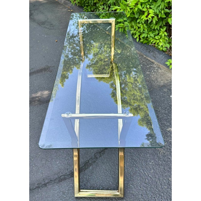 Simple brass and glass sofa/console table from the 80s. Nice size. It would fit nicely behind a sofa or along a wall in a...