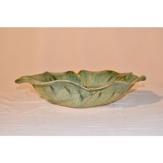 Wonderfully hand thrown pottery bowl in the shape of an open flower blossom. Lovely shades of green and blue in varying...