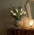 A mid-century modern studio art glass vase featuring a squat, spherical body with a thick, heavy clear cased base. The...