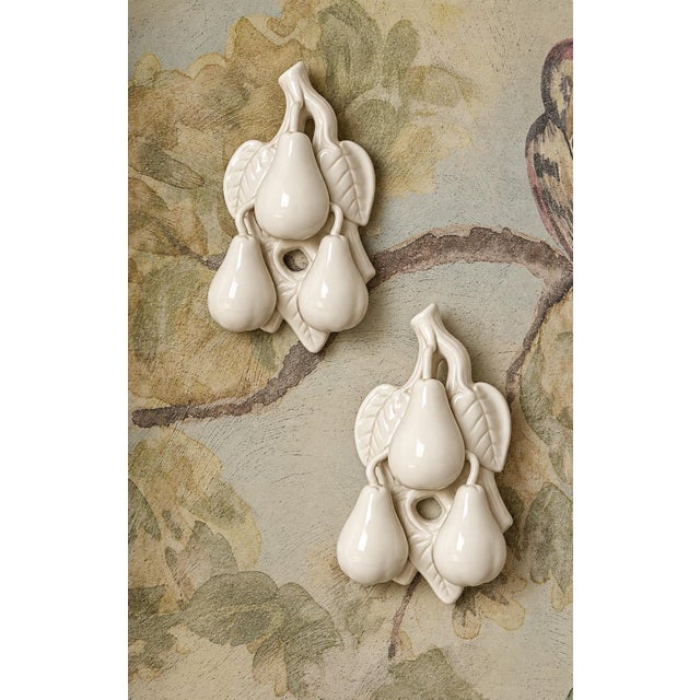 Lovely pair of vintage French P-V France white ceramic pears featuring beautifully embossed detailing and an elegant...