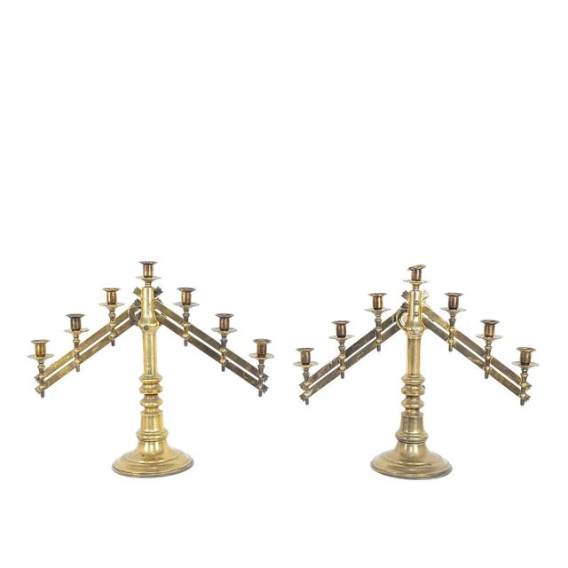 A pair of brass Gothic style candelabras, made in England circa 1900.