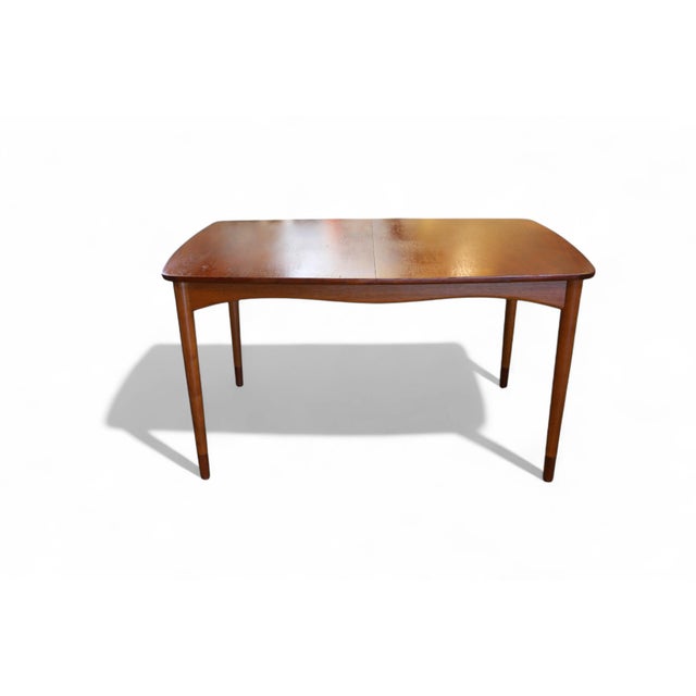 An iconic dining table, meticulously crafted by the highly respected and valued designer Finn Juhl for the venerable...