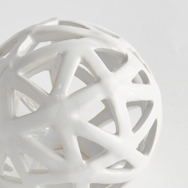 This contemporary little orb is made of thin ceramic strips giving it an open feel. It is perfect in a wide open bowl or...