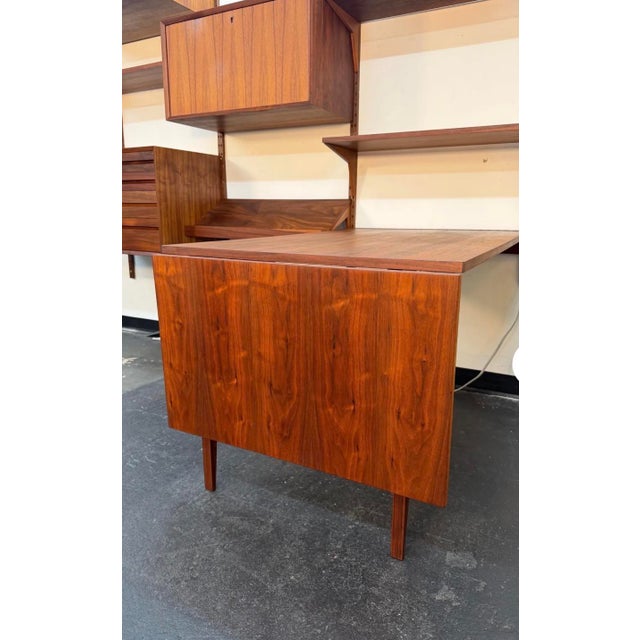 Mid Century Modern wall mounted modular wall unit system designed by Poul Cadovius for Cado. Fully refinished 3 bay unit...