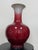 Mid-20th-century Chinese porcelain bottle vase finished in a tonal sang de boeuf, or oxblood, glaze. Its substantial scale...