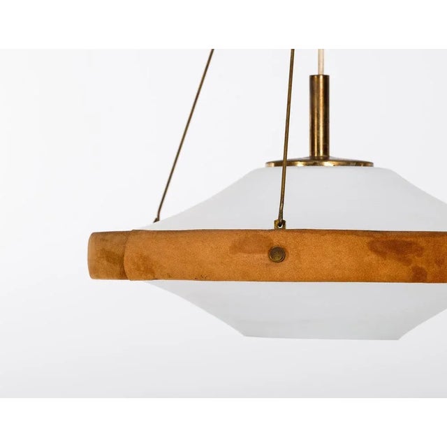 Swedish glass, brass & suede pendant, 1960s. Very good condition. Up to 250V (Europe/UK Standard).The wiring of this item...