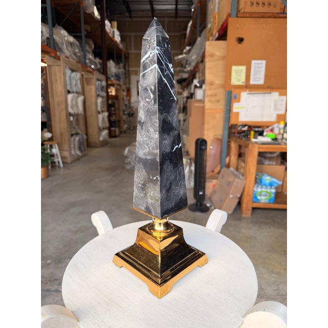 Add a bold architectural statement to your décor with this contemporary obelisk sculpture, expertly crafted from genuine...