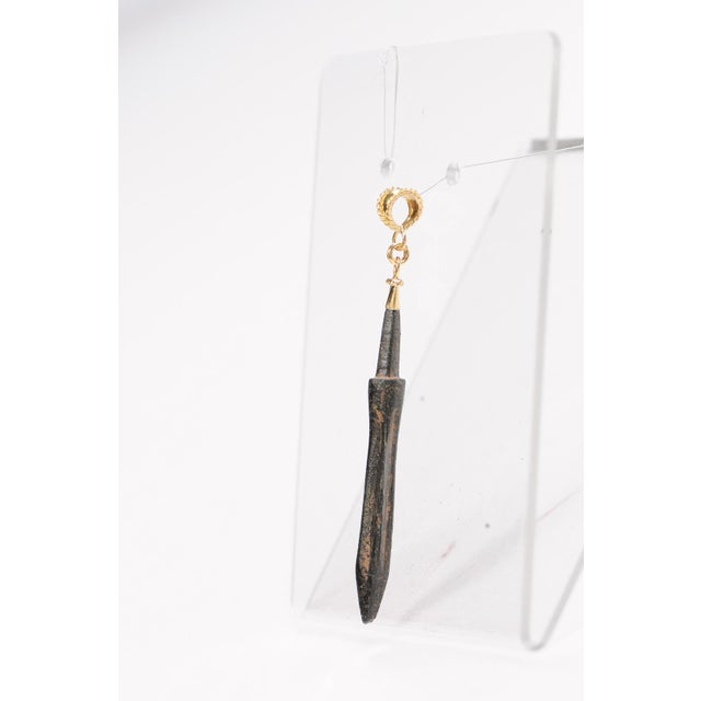 An ancient Roman spear head pendant from the 1st to 3rd Century AD. This unique oxblood, bronze artifact has been artfully...