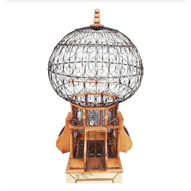 20th Century Victorian style wood and iron "Balloon" Bird Cage & Feeder. This ornamental piece features, mahogany stained...