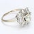 This is a floral themed 14k White Gold Ring featuring One 0.56ct. K/I1 Brilliant Yellow Diamond Center & ~0.28ctw of H/SI2...