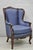 Antique French Renaissance Louis XV Style Carved Walnut Wingback Arm Chair with Blue Fabric. Circa Early 20th Century....