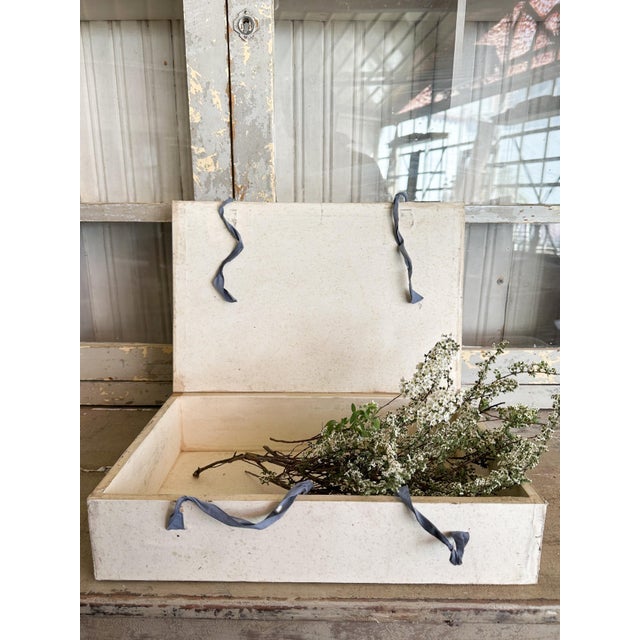 Set of four Italian decorative storage boxes designed to resemble traditional books, each featuring a marbled paper-...