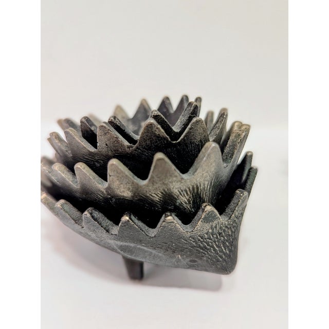 A vintage Walter Bosse cast iron hedgehog figurine featuring a set of 6 nesting hedgehogs the designer’s signature...