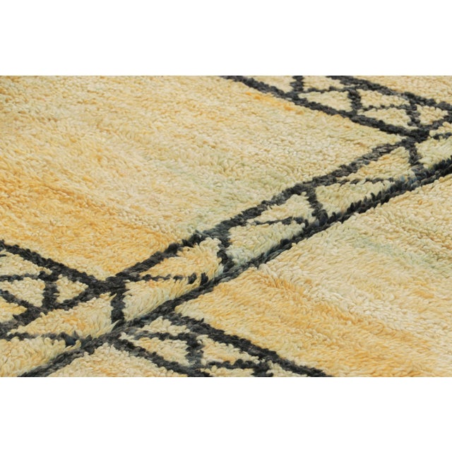 Hand-knotted in wool and originating from Morocco circa 1950-1960, this 5x9 vintage rug is a rare and among the most...