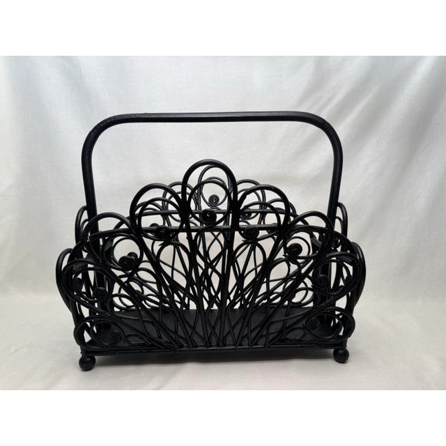 A Boho Chic style is exhibited on this open design magazine rack. Made of rattan and painted black it is a moderate size...