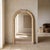 1980s Postmodern Tessellated Stone Arched Wall Mirror. A sculptural arched mirror framed in pale tessellated stone with...