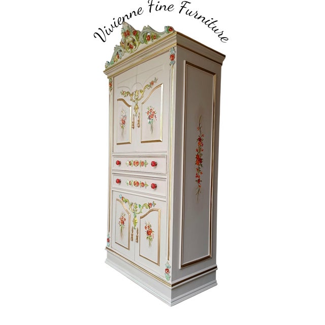 This Venetian-style wedding armoire features characteristic hand-painted floral motifs and gilded accents common in...