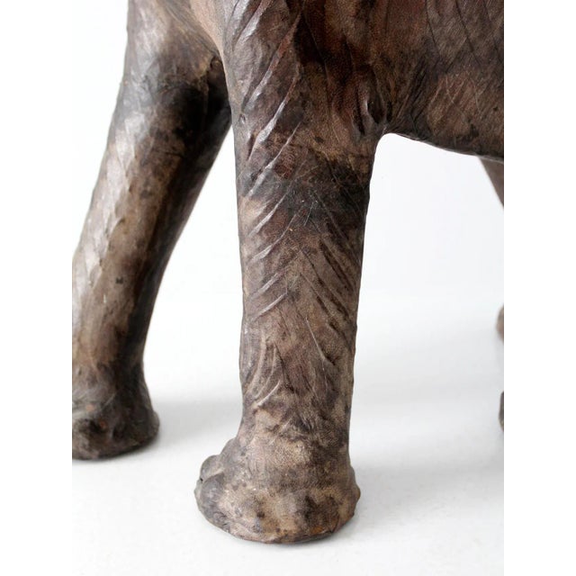 This is an antique leather elephant sculpture. The hand-crafted figure features beautifully aged leather with glass eyes,...