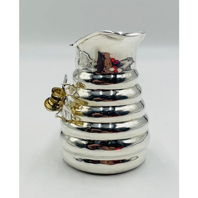 A delightfully charming 1960s Los Castillo silver-plated pitcher that feels as if it fluttered straight out of a magical...