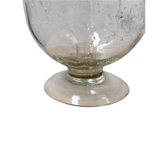 A pair of large blown glass hurricanes. Beautiful set with white pillars for your tablescape.