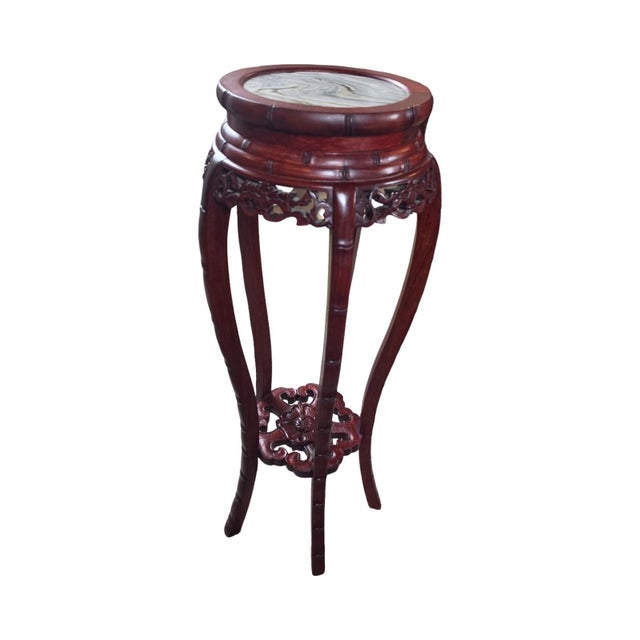 Elegant vintage Chinese-style pedestal or plant stand crafted in richly finished dark red mahogany-toned wood with a round...