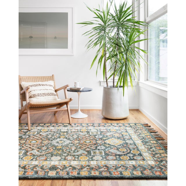 Hooked of 100% wool by skilled artisans in India, this collection of transitional rugs is soft to the touch and displays...