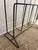This vintage mid-century modern magazine rack features a minimalist wireframe design constructed from solid black-painted...