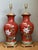 This exquisite pair of vintage table lamps features a vibrant coral-red glazed ceramic finish, beautifully adorned with...