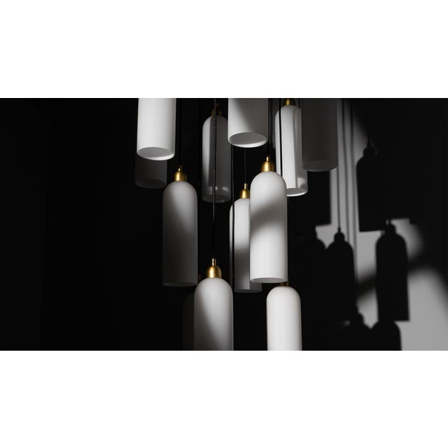 Odyssey Cluster 13 Chandelier, Opal Glass and Brass, Contemporary, in Stock Offered by Schwung A gleaming constellation of...