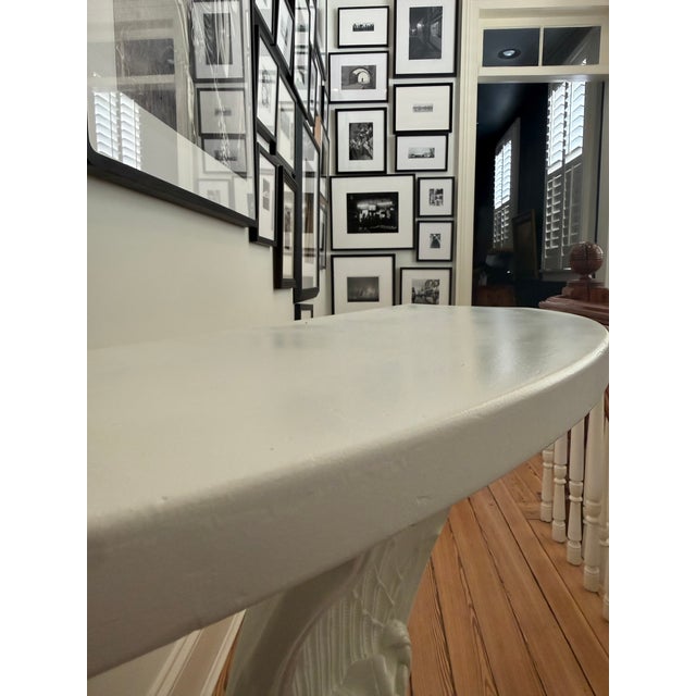 This is a beautiful classic Hollywood Regency style console table painted in a white finish, in the manner of Grosfeld...