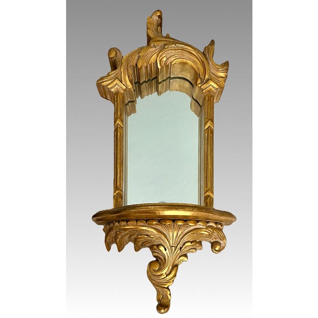Ornate Baroque or Hollywood Regency style wall mirror with Italian flair. This piece features an integrated mirror and...