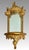 Ornate Baroque or Hollywood Regency style wall mirror with Italian flair. This piece features an integrated mirror and...