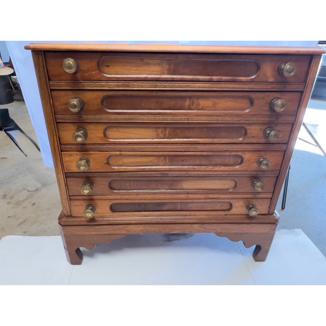 Beautiful walnut map or sewing table great used as an end table. The table has 6 drawers with what looks like could have...