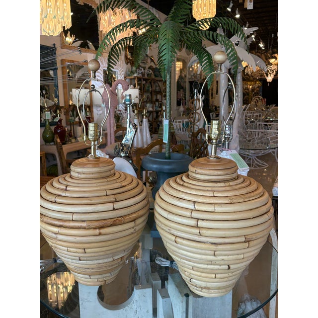Amazing pair of vintage 1970s rattan oversized table lamps. Meticulously restored with clear coat matte lacquer, all new 3...