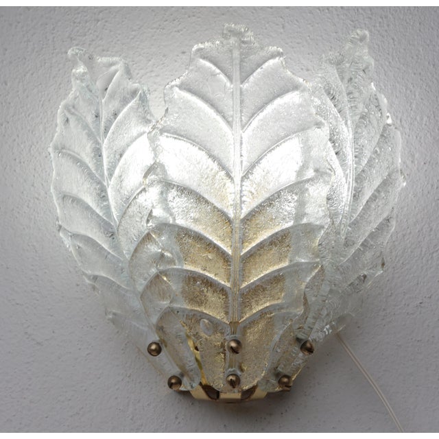 Stunning set of 2 of Murano Glass wall lamps. Each lamp is composed of 3 leaves in transparent murano glass. Two light...