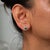 Two colombian emerald stones, emerald cut and 1 carats in total, sit at the centre of this pair of solid 14K yellow gold...