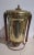 Vintage brass coffee urn dispenser with warm wood accents on the side handles, lid finial, and spigot handle....