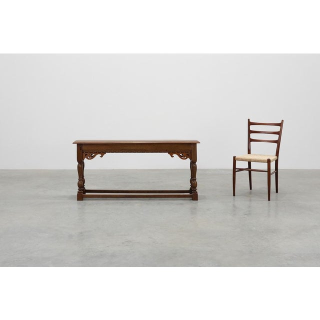 A rare 17th‑century Jacobean bench in solid oak, exemplifying the robust craftsmanship and decorative vocabulary of early...