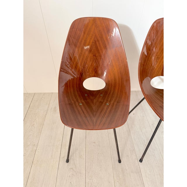 Six Medea chairs in curved plywood and a painted metal frame. An iconic 1950s model. When creativity entered the Brianza...