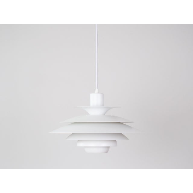 This lamp was designed by Danish designer Kurt Wiborg and manufactured by Jeka. The lamp's form is based on the principle...