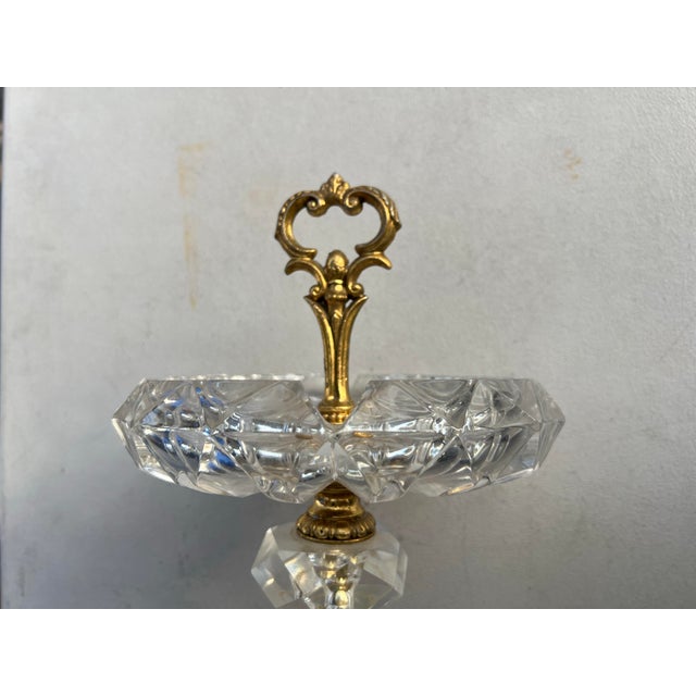 Hollywood Regency Style. This is a vintage standing crystal and brass floor ashtray. The piece features an ornate brass...