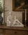A handsome circa-1960s Italian porcelain sculpture depicting a classically draped reclining male figure holding a...