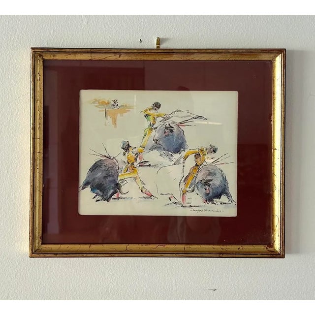 Framed and Signed. Signed lower right. Set of 2 Watercolor scenes depicting Bulls and bull Fighting. Measurements: 12” w x...