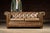 Vintage tufted leather sofa. Stylishly distressed, this piece features an all-over brown/tan gradient with a "roughened"...