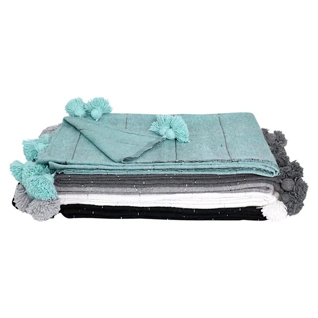 Our Moroccan Pom Pom blankets are 100% pure wool, Handwoven on wooden Looms by local artisans in Marrakech. Size: 72" x 113"