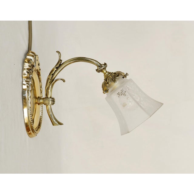 Brass Wall Lamps Set of 3 wall-mounted lamps, circa 1900. Solid cast brass, Clear glass shades with Art Nouveau motif,...