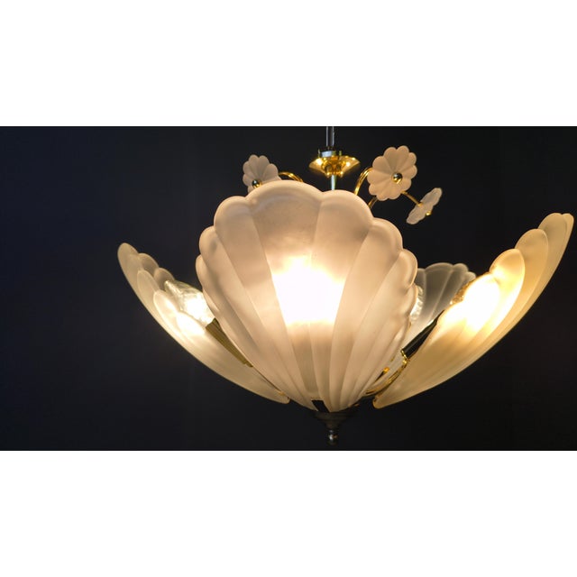 Stunning italian glass chandelier with a brass frame. The chandelier has glass art deco style shell shades and decorative...