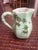 Japanese Celadon Pitcher with hand painted enamel and gold flowers. It has a bamboo style handle and is very pretty for a...